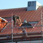 A man on a roof working on a roof